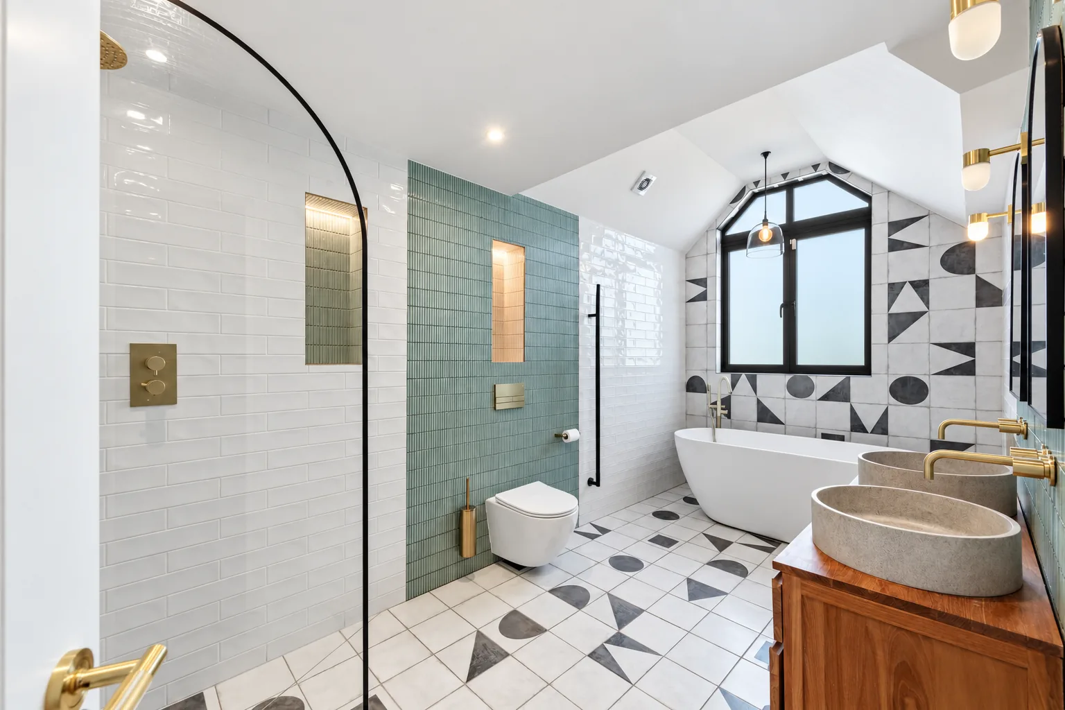 Bathroom with walk-in shower, freestanding bath and twin stone basins