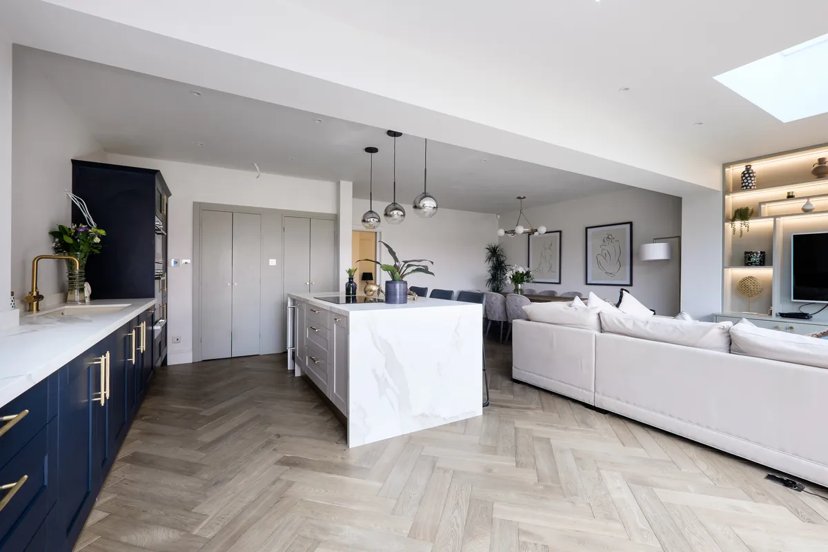 Open-plan kitchen and living space in a rear extension, with a marble island and rooflights